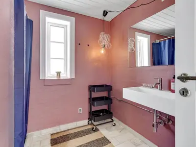 a bathroom with a sink and a mirror at Holiday Home Bernice - 150m from the sea by Interhome in Torsted