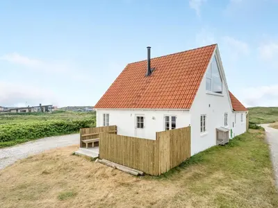 a white house with an orange roof on a field at Holiday Home Bernice - 150m from the sea by Interhome in Torsted