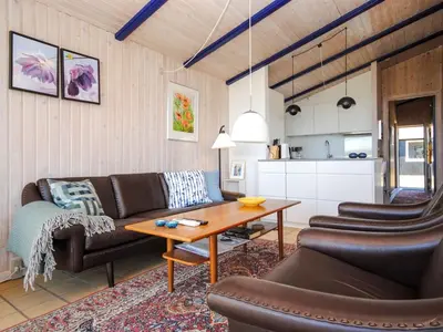 a living room with a couch and a table at Holiday Home Jerrik - 900m from the sea by Interhome in Torsted