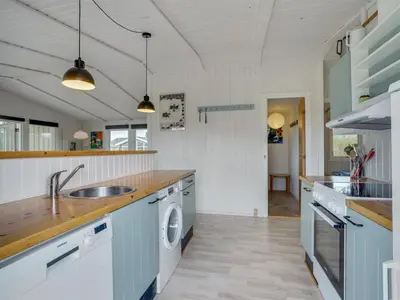 a kitchen with a sink and a washing machine at Holiday Home Mads - 950m from the sea by Interhome in Torsted