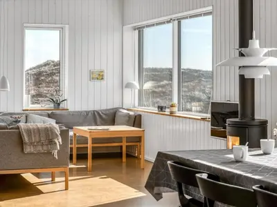 a living room with a couch and a table at Holiday Home Ginne - 125m from the sea by Interhome in Torsted