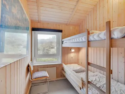 a room with two bunk beds and a window at Holiday Home Rosali - 500m from the sea by Interhome in Torsted