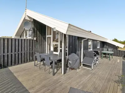 a deck with a tent and a table and chairs at Holiday Home Rosali - 500m from the sea by Interhome in Torsted