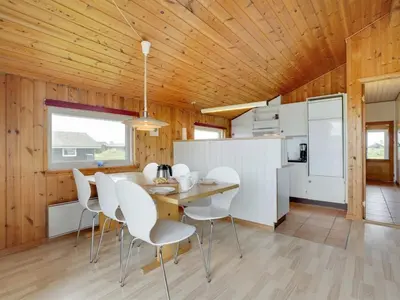 a kitchen and dining room with a wooden ceiling at Holiday Home Joern - 300m from the sea by Interhome in Torsted