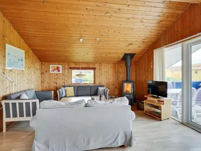 a living room with a couch and a tv at Holiday Home Joern - 300m from the sea by Interhome in Torsted