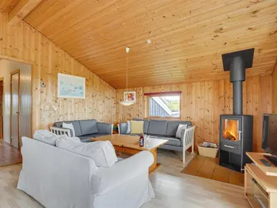a living room with a couch and a fireplace at Holiday Home Joern - 300m from the sea by Interhome in Torsted