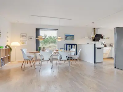 a kitchen and dining room with a table and chairs at Holiday Home Fridolina - 200m from the sea by Interhome in Torsted
