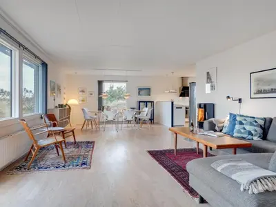 a living room with a couch and a table at Holiday Home Fridolina - 200m from the sea by Interhome in Torsted