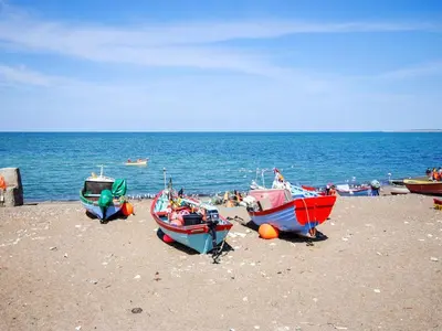 a group of boats sitting on the beach at Holiday Home Ansfried - 900m from the sea by Interhome in Torsted