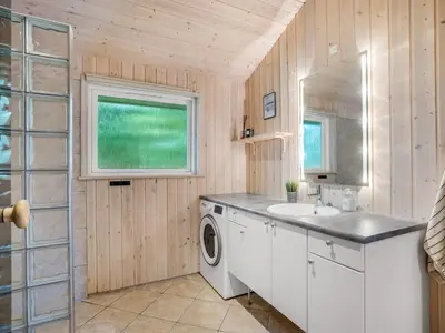 a laundry room with a sink and a washing machine at Holiday Home Ansfried - 900m from the sea by Interhome in Torsted