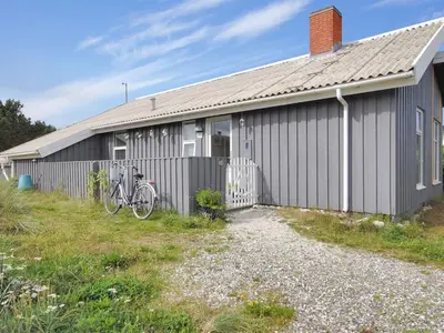 a house with a bike parked outside of it at Holiday Home Dode - 225m from the sea by Interhome in Torsted