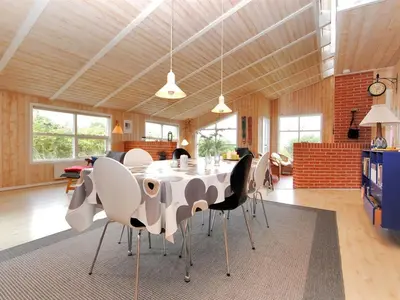 a dining room with a table and chairs at Holiday Home Dode - 225m from the sea by Interhome in Torsted