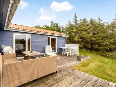 a patio with a table and chairs on a deck at Holiday Home Kanerva - 350m from the sea by Interhome in Torsted