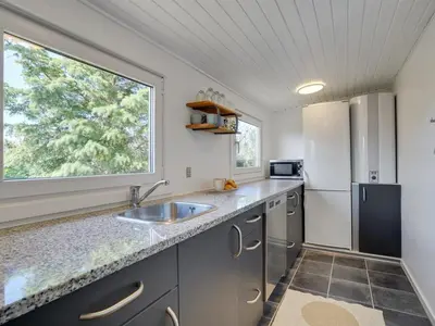 a kitchen with a sink and a refrigerator at Holiday Home Kanerva - 350m from the sea by Interhome in Torsted