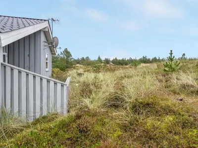 a house sitting on top of a grass covered hill at Holiday Home Tino - 900m from the sea by Interhome in Torsted