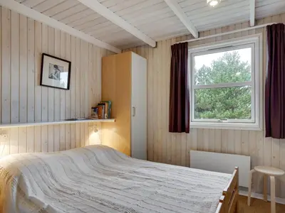 a bedroom with a bed and a window at Holiday Home Tino - 900m from the sea by Interhome in Torsted