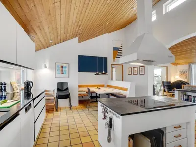 a kitchen with white counters and a wooden ceiling at Holiday Home Teijo - 400m from the sea by Interhome in Torsted