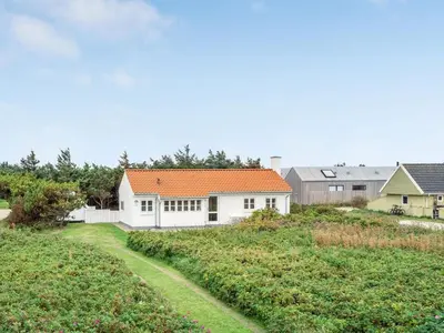 a white house with an orange roof at Holiday Home Meindor - 350m from the sea by Interhome in Torsted