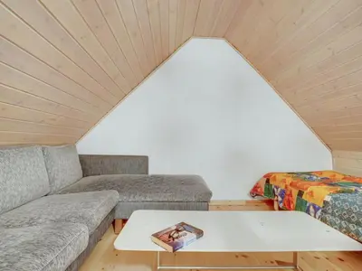 a living room with two couches and a table at Apartment Nermin - 300m from the sea by Interhome in Torsted