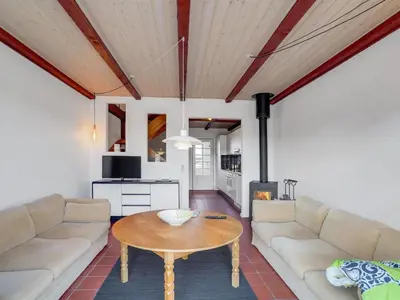 a living room with a couch and a table at Apartment Nermin - 300m from the sea by Interhome in Torsted