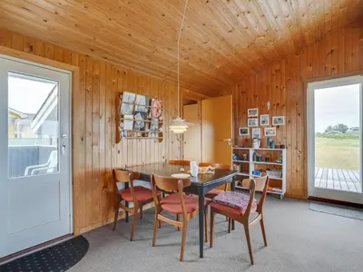a dining room with a table and chairs at Holiday Home Svea - 400m from the sea by Interhome in Torsted