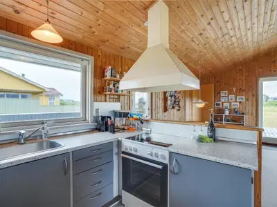 a kitchen with a sink and a stove at Holiday Home Svea - 400m from the sea by Interhome in Torsted
