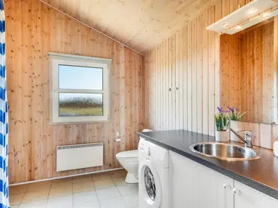 a bathroom with a sink and a toilet at Holiday Home Abel - 350m from the sea by Interhome in Løkken