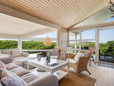 a living room with couches and a table at Holiday Home Abel - 350m from the sea by Interhome in Løkken