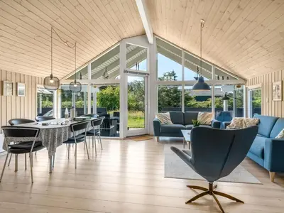 a living room with a dining table and chairs at Holiday Home Federica - 500m from the sea by Interhome in Løkken