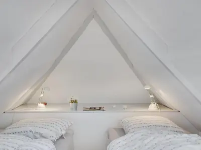 a bedroom with two beds and a white roof at Holiday Home Tabea - 150m from the sea by Interhome in Løkken