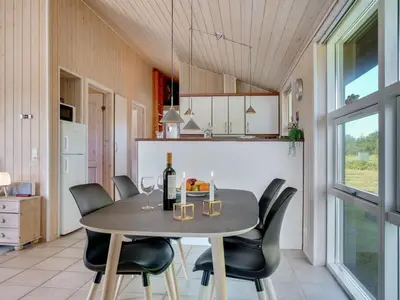 a dining room with a table and chairs at Holiday Home Elsabet - 750m from the sea by Interhome in Løkken