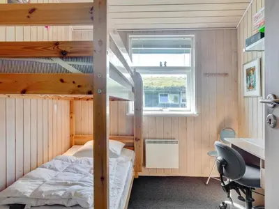 a bedroom with a bunk bed and a desk at Holiday Home Elsabet - 750m from the sea by Interhome in Løkken