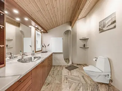 a bathroom with a toilet and a sink at Holiday Home Sunneva - 1km from the sea by Interhome in Løkken
