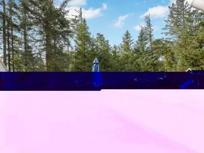 a blue fence in front of some trees at Holiday Home Sunneva - 1km from the sea by Interhome in Løkken