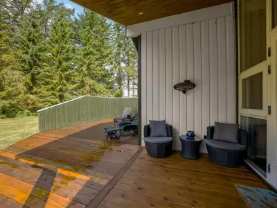 a patio with two chairs and a table on a house at Holiday Home Sunneva - 1km from the sea by Interhome in Løkken