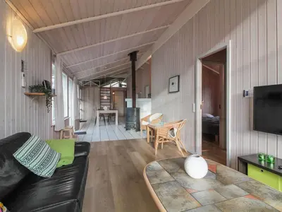 a living room with a couch and a table at Holiday Home Panu - 600m from the sea by Interhome in Løkken