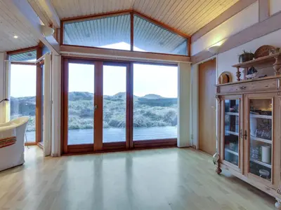 a large room with a large glass door with a view at Holiday Home Essie - 250m from the sea by Interhome in Løkken