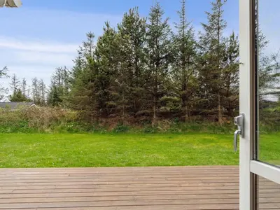 an open door with a view of a yard at Holiday Home Aleta - 500m from the sea by Interhome in Løkken
