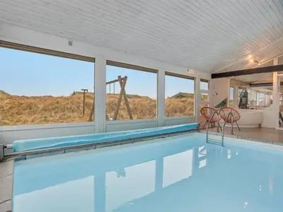 a swimming pool with a view of the desert from a house at Holiday Home Falka - 800m from the sea by Interhome in Løkken