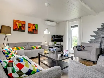 a living room with couches and a coffee table at Holiday Home Dome - 750m from the sea by Interhome in Løkken