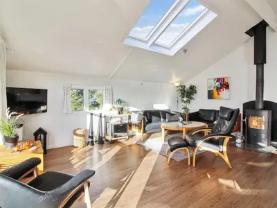 a living room filled with furniture and a skylight at Holiday Home Annalisa - 1-2km from the sea by Interhome in Løkken
