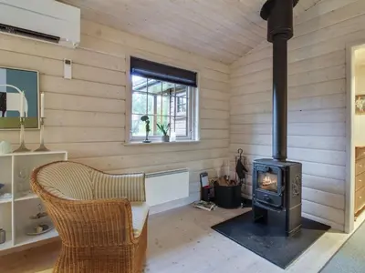 a living room with a wood stove in a room at Holiday Home Jo - 1-2km from the sea by Interhome in Løkken