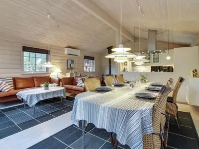 a large living room with a table and chairs at Holiday Home Jo - 1-2km from the sea by Interhome in Løkken