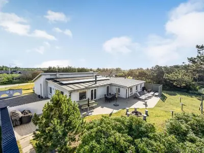 an aerial view of a white house with a yard at Holiday Home Lenni - 700m from the sea by Interhome in Løkken