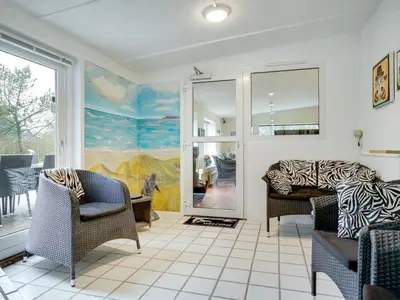 a living room with two chairs and a couch at Holiday Home Lenni - 700m from the sea by Interhome in Løkken