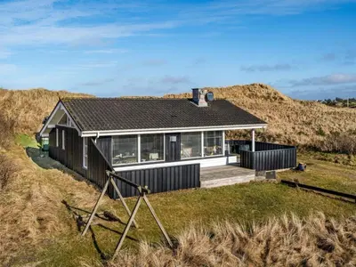 a house on top of a grassy field at Holiday Home Ofrath - 350m from the sea by Interhome in Løkken