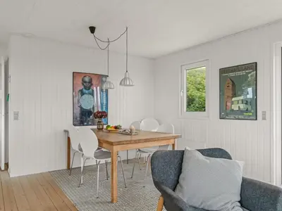 a dining room with a table and chairs at Holiday Home Thorfrid - 150m from the sea by Interhome in Løkken