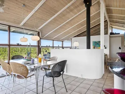 a dining room with a table and chairs at Holiday Home Danica - 175m from the sea by Interhome in Løkken