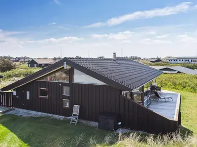 a house with a solar roof on a deck at Holiday Home Danica - 175m from the sea by Interhome in Løkken