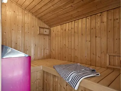 a wooden sauna with a zebra blanket in it at Holiday Home Danica - 175m from the sea by Interhome in Løkken